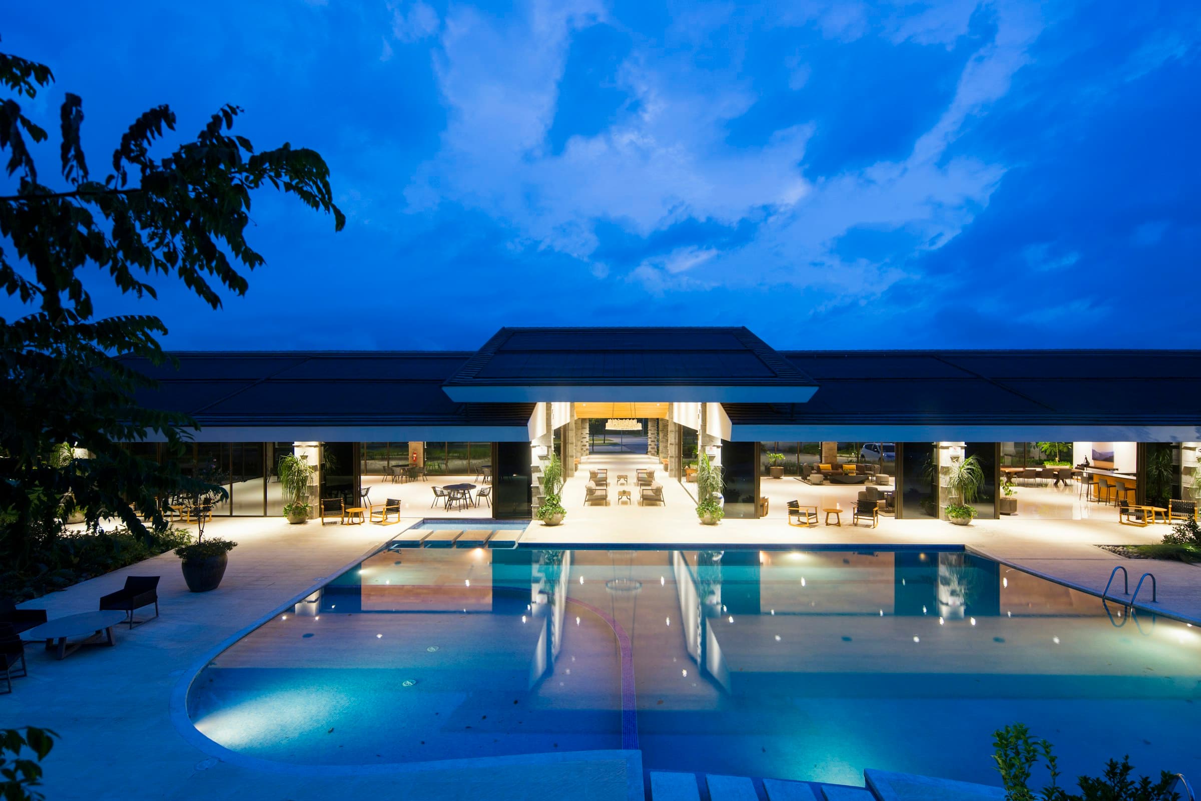 Resort pool at dusk with warm ambient lighting