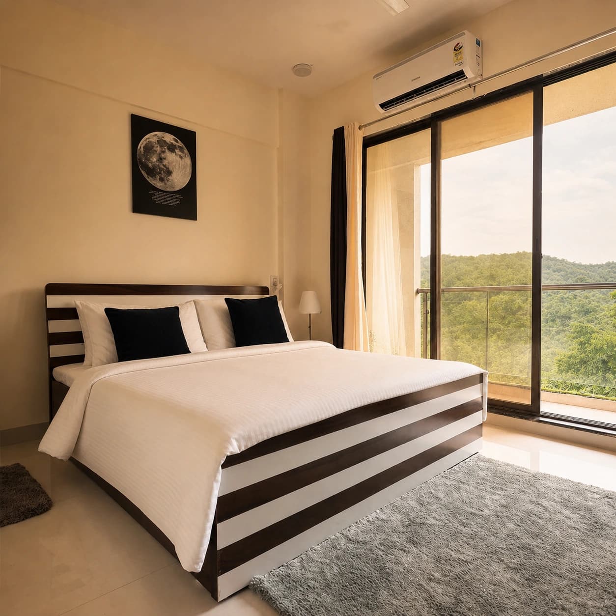 Deluxe double room with striped bed and forest view from the balcony