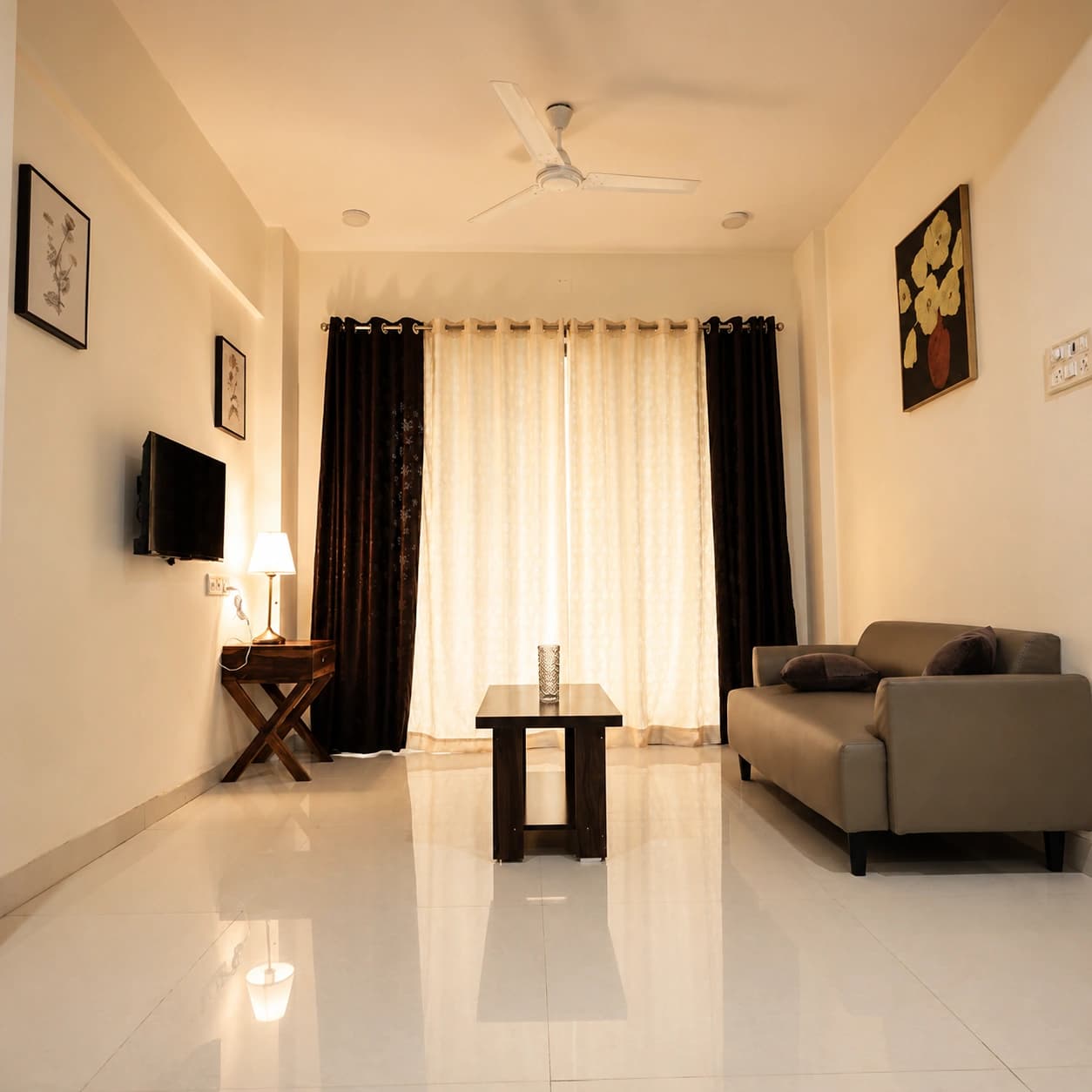 Living area with sofa, coffee table and mountain-view curtains