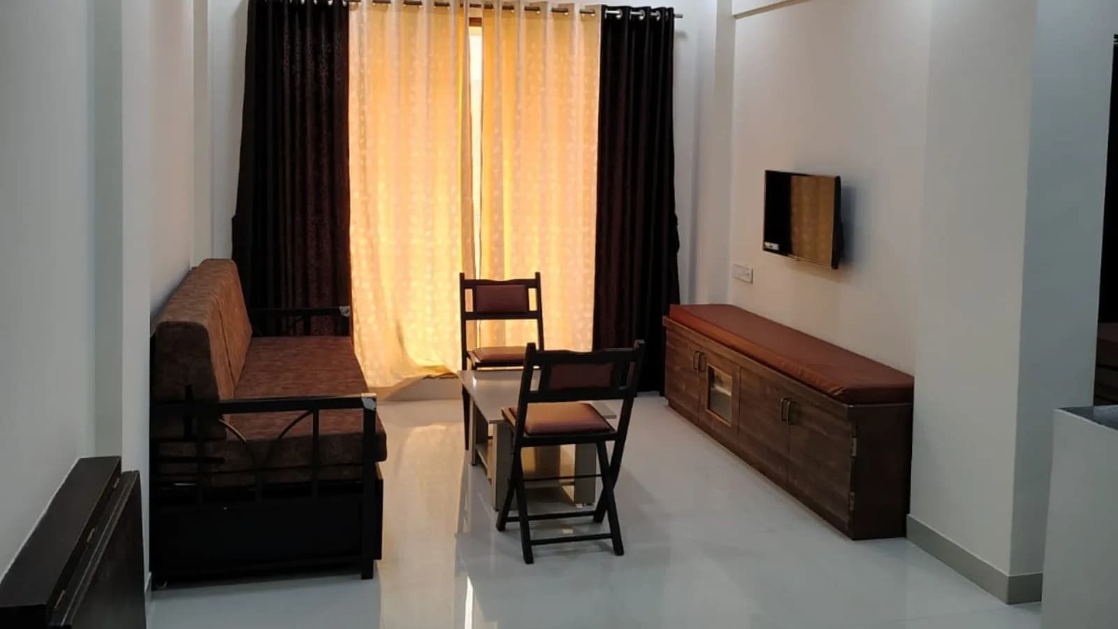Family suite lounge with a sofa, seating and warm curtains