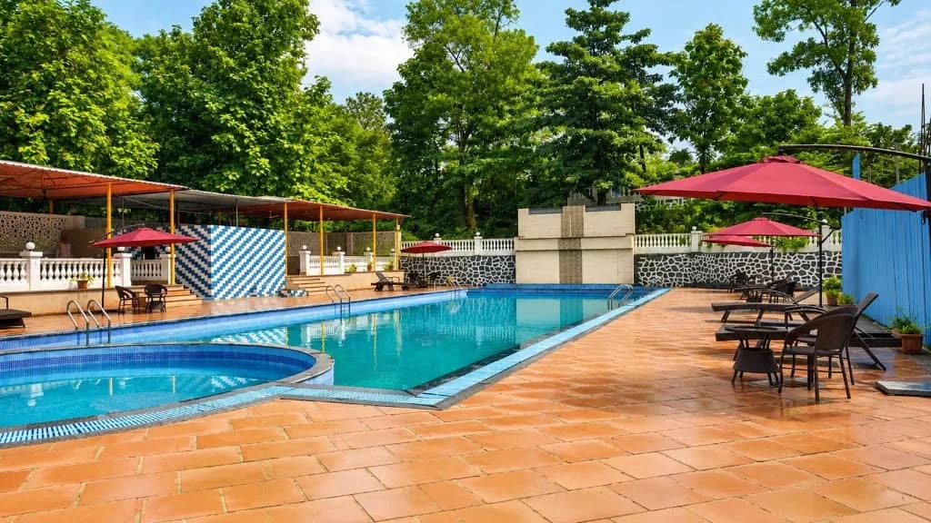 Resort swimming pool with terracotta deck and lounge chairs